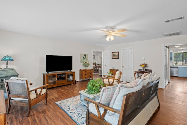 living room with ceiling fan and dark hardwood / wood-style floors