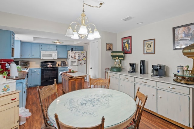 dining space featuring an inviting chandelier and dark hardwood / wood-style flooring