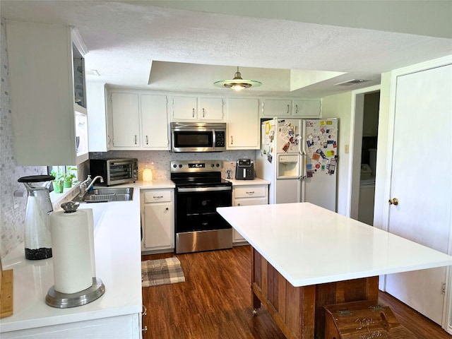 11404 Fm 1826, Austin, TX 78737 - kitchen with appliances with stainless steel finishes, dark wood-style flooring, light countertops, a sink, and decorative backsplash