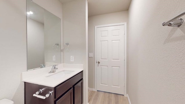 bathroom featuring vanity and hardwood / wood-style floors