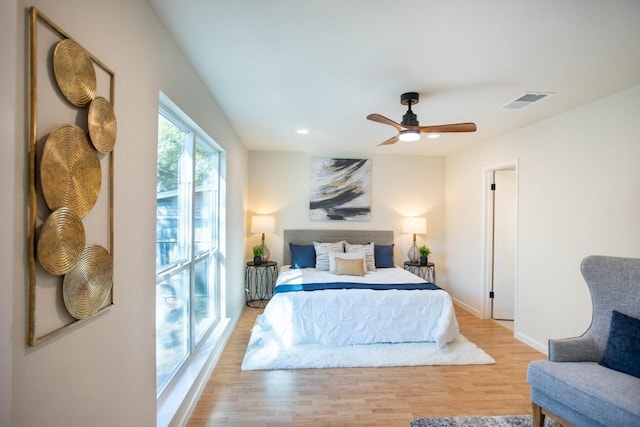 bedroom with ceiling fan and light hardwood / wood-style floors