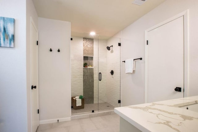 bathroom with tile patterned floors, vanity, and a shower with shower door