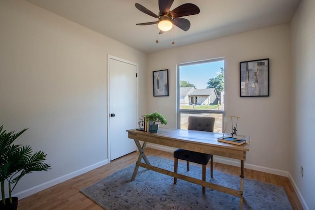 office with ceiling fan and hardwood / wood-style floors