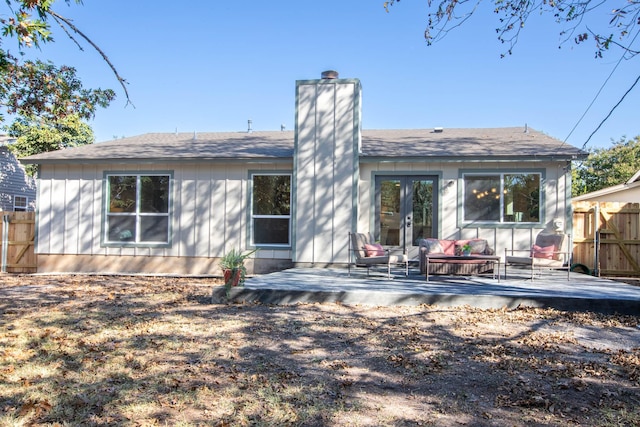 rear view of house with french doors and a wooden deck