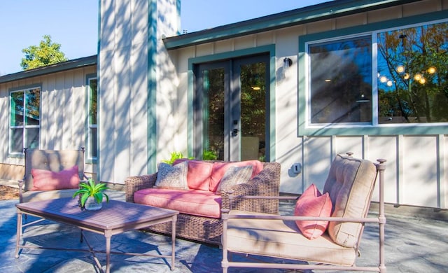 wooden terrace with an outdoor hangout area, a patio area, and french doors