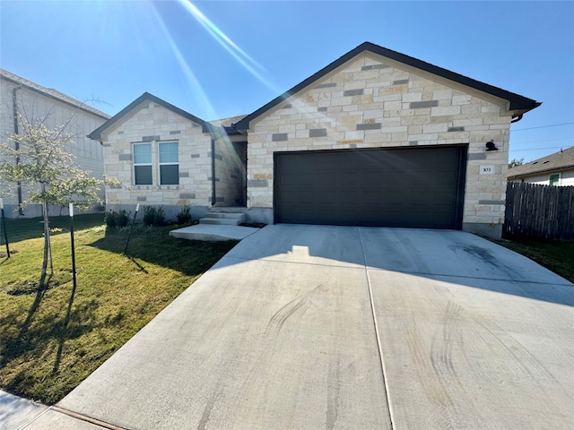 view of front of home with a front lawn and a garage