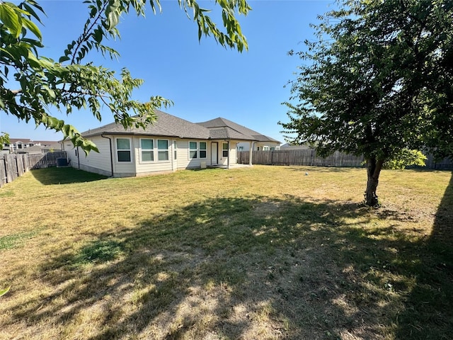 rear view of property with a yard