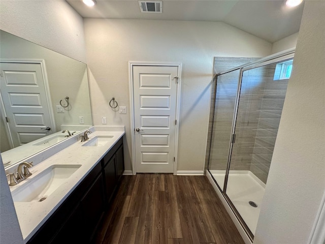 bathroom with vanity, an enclosed shower, hardwood / wood-style flooring, and lofted ceiling