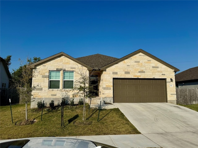 view of front of house featuring a front lawn and a garage