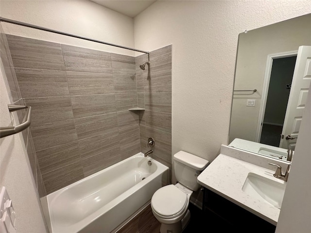 full bathroom featuring vanity, tiled shower / bath combo, and toilet