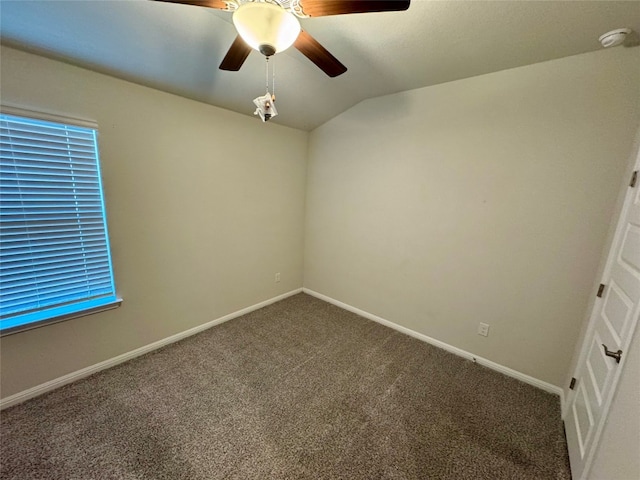 carpeted empty room featuring lofted ceiling and ceiling fan