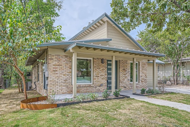 view of front facade with cooling unit and a front lawn