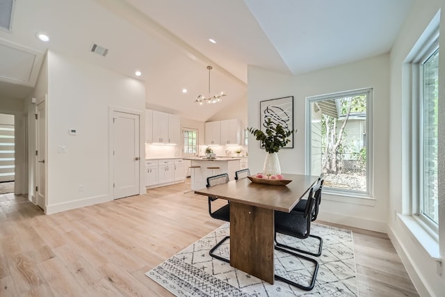 dining area featuring beam ceiling, light hardwood / wood-style flooring, a notable chandelier, and high vaulted ceiling