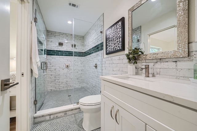 bathroom with an enclosed shower, toilet, vanity, decorative backsplash, and tile patterned flooring