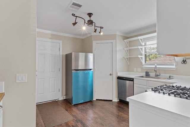 kitchen with sink, stainless steel appliances, white cabinets, ornamental molding, and dark hardwood / wood-style floors