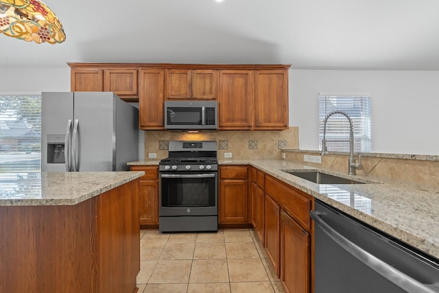 kitchen featuring sink, light tile patterned flooring, appliances with stainless steel finishes, light stone counters, and tasteful backsplash