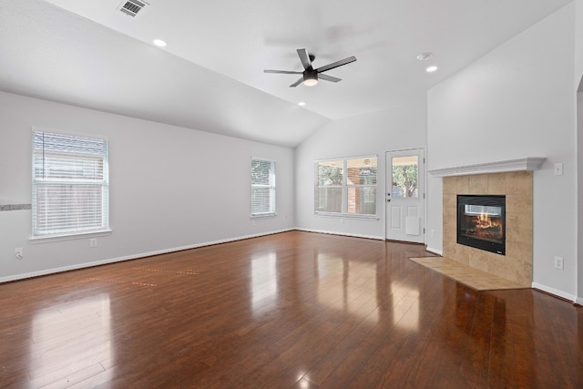 unfurnished living room with dark wood-type flooring, ceiling fan, vaulted ceiling, and a fireplace