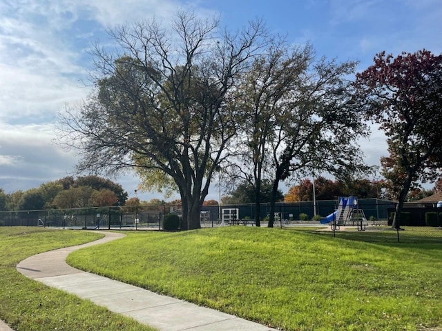 view of property's community with a yard and a playground