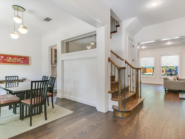 dining room featuring crown molding and dark hardwood / wood-style floors