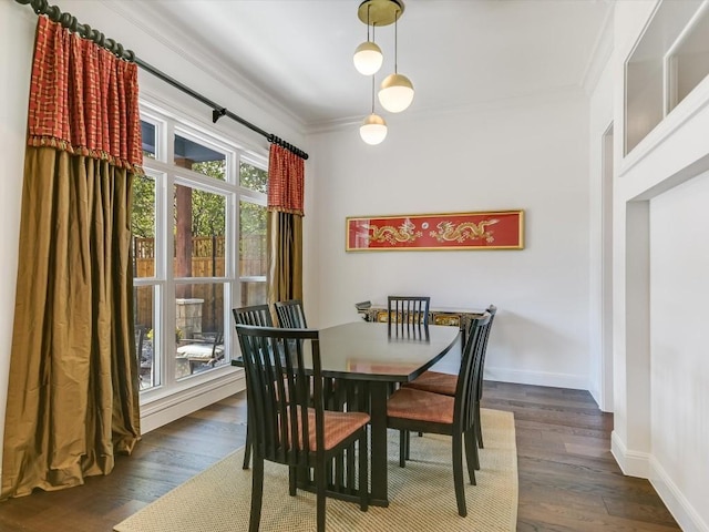 dining area with a healthy amount of sunlight, dark hardwood / wood-style floors, and ornamental molding