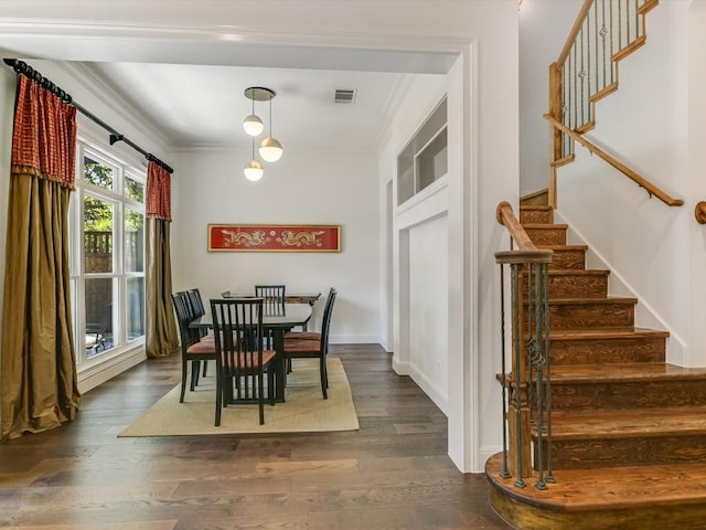 dining room with dark hardwood / wood-style floors and ornamental molding