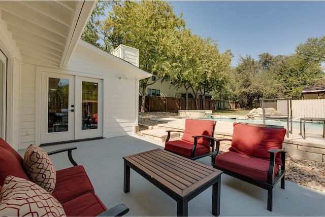 view of patio / terrace featuring a fenced in pool and french doors