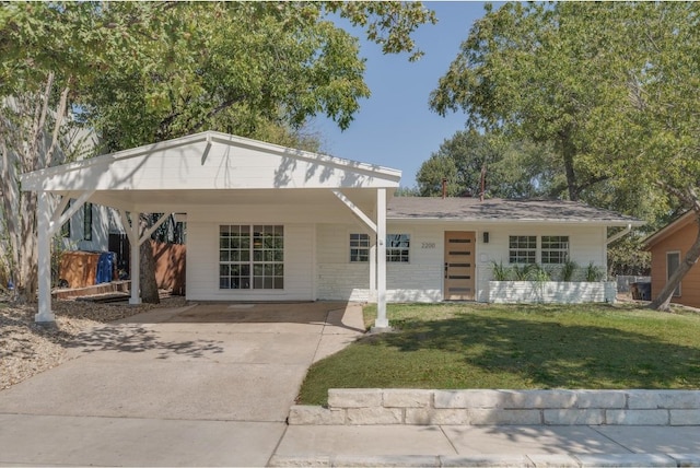 view of front of house with a front lawn and a carport