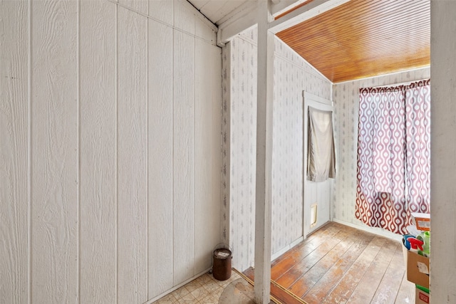 bathroom featuring wood walls, wood-type flooring, and wooden ceiling