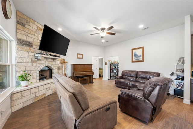 living room with hardwood / wood-style floors, a fireplace, and ceiling fan