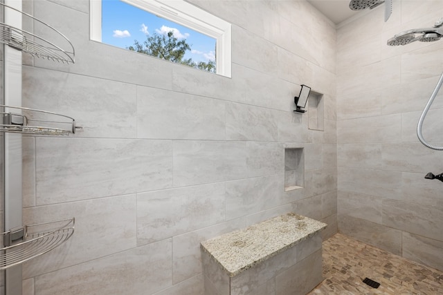 bathroom with a tile shower