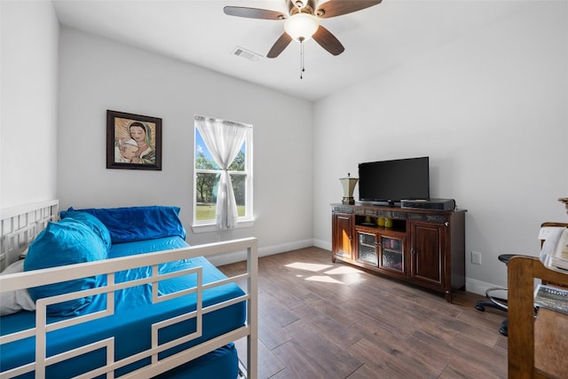 bedroom with ceiling fan and dark hardwood / wood-style flooring