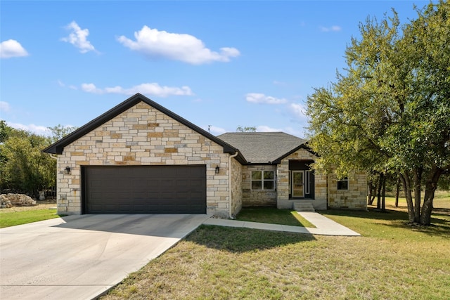 view of front of house with a front yard and a garage