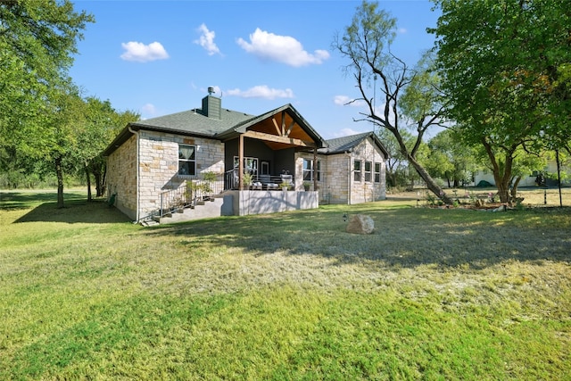 back of house with a yard and a patio area