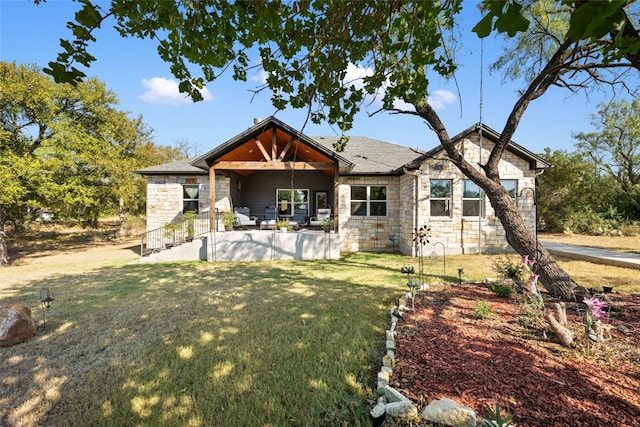 rear view of house featuring a yard