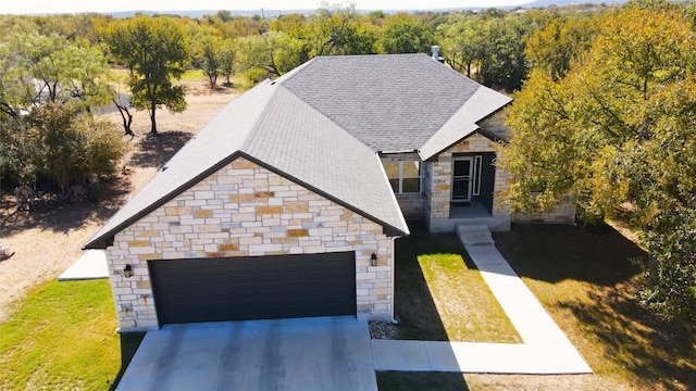 view of front of property with a front lawn and a garage