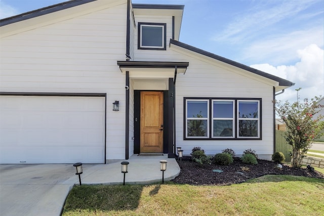 view of front of property featuring a garage and a front yard