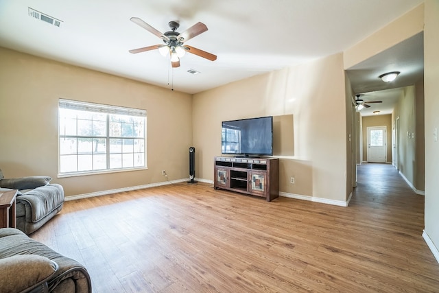 living room featuring hardwood / wood-style floors and ceiling fan