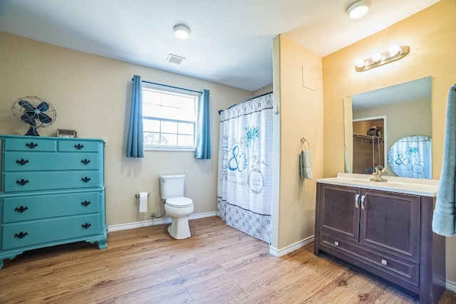 bathroom with vanity, hardwood / wood-style flooring, toilet, and curtained shower