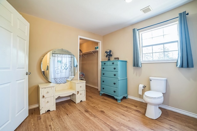 bathroom with wood-type flooring and toilet