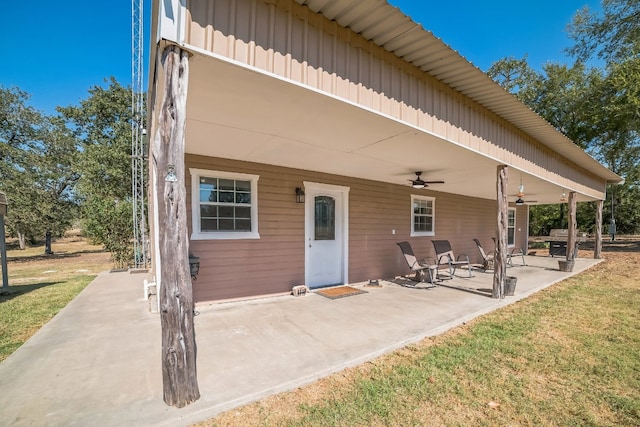 back of house with a yard, a patio, and ceiling fan