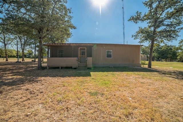 back of house featuring a yard