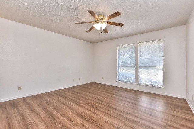 spare room featuring ceiling fan, wood-type flooring, and a textured ceiling