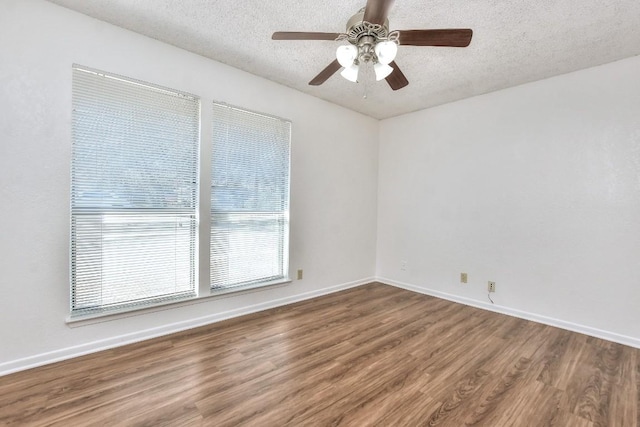 unfurnished room featuring ceiling fan, wood-type flooring, and a textured ceiling