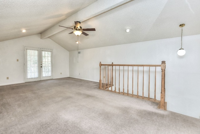 carpeted empty room featuring vaulted ceiling with beams, ceiling fan, french doors, and a textured ceiling