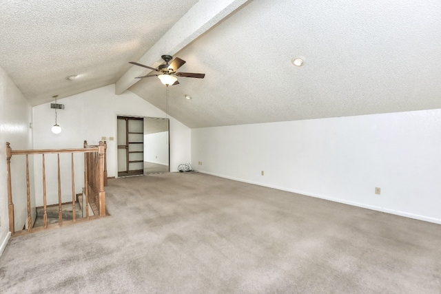 bonus room featuring carpet, vaulted ceiling with beams, ceiling fan, and a textured ceiling