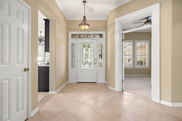 foyer featuring ceiling fan and crown molding