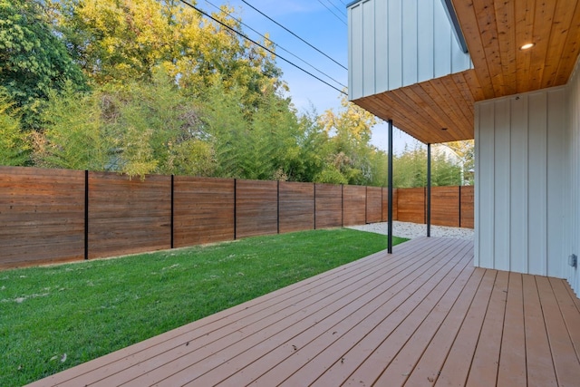 wooden deck with a lawn