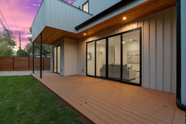 deck at dusk with a lawn