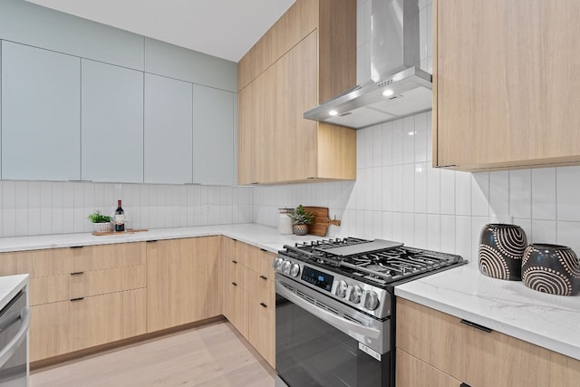 2704 Canterbury St Unit A, Austin, TX 78702 - kitchen featuring wall chimney range hood, light brown cabinets, and appliances with stainless steel finishes