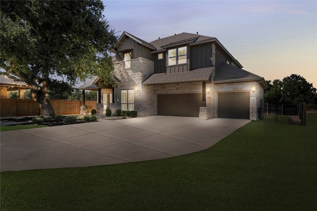 view of front facade featuring a garage and a lawn